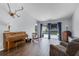Spacious living room with wood-look tile floors and sliding glass doors to the screened patio at 2203 Essex Dr, Ocoee, FL 34761
