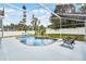 Screened in backyard pool area with a white fence, lounge chairs, and plenty of room for entertaining at 2203 Essex Dr, Ocoee, FL 34761