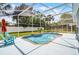 This backyard pool area is screened in with a white fence, seating area, and plenty of space to relax at 2203 Essex Dr, Ocoee, FL 34761