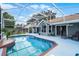 Screened in pool area with patio furniture and a bright blue pool with brick trim at 2203 Essex Dr, Ocoee, FL 34761
