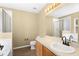 This is a standard bathroom featuring a shower and tub combo with a vanity and mirror at 2488 Hassonite St, Kissimmee, FL 34744