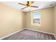 This bedroom has neutral walls, a ceiling fan and carpeted floors at 2488 Hassonite St, Kissimmee, FL 34744