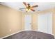 This bedroom features neutral paint, a ceiling fan, and good closet space at 2488 Hassonite St, Kissimmee, FL 34744