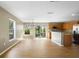 Bright dining space with wood floors, sliding glass doors, and adjacent modern kitchen area at 2488 Hassonite St, Kissimmee, FL 34744