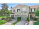 Exterior front view of townhome showcasing driveway and landscaping at 2488 Hassonite St, Kissimmee, FL 34744