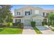 Exterior front elevation of a two-story townhome with a well-manicured lawn at 2488 Hassonite St, Kissimmee, FL 34744