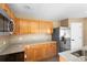 Well-lit kitchen with granite countertops, stainless steel fridge, and modern appliances at 2488 Hassonite St, Kissimmee, FL 34744