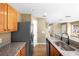 Kitchen featuring granite counters, stainless steel appliances, and access to multiple rooms at 2488 Hassonite St, Kissimmee, FL 34744