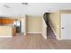 Open concept living space with wood laminate flooring and staircase at 2488 Hassonite St, Kissimmee, FL 34744