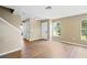 Bright and airy living room with wood floors and a staircase leading to the upper level at 2488 Hassonite St, Kissimmee, FL 34744