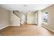Neutral living room features wood floors, staircase, and a bright window for natural light at 2488 Hassonite St, Kissimmee, FL 34744