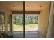 View of the private, fenced backyard from the covered lanai with mature trees at 2585 Woodside Ridge Dr, Apopka, FL 32712