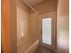 Bathroom featuring shower with tub, tile surround, and door to outside at 2585 Woodside Ridge Dr, Apopka, FL 32712