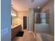 Bright bathroom featuring dual sinks, a separate shower, and a relaxing soaking tub at 2585 Woodside Ridge Dr, Apopka, FL 32712