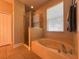 Bright bathroom featuring a shower and a large soaking tub at 2585 Woodside Ridge Dr, Apopka, FL 32712