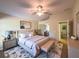 Well staged bedroom showcasing a ceiling fan, bed, bench, and modern decor at 2585 Woodside Ridge Dr, Apopka, FL 32712