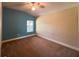 Bedroom with carpeted floors, ceiling fan, and natural light from the window at 2585 Woodside Ridge Dr, Apopka, FL 32712