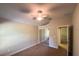 Neutral bedroom featuring a ceiling fan, mirrored closet and neutral colors at 2585 Woodside Ridge Dr, Apopka, FL 32712