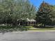 Attractive single-story home with a well-kept lawn and mature trees at 2585 Woodside Ridge Dr, Apopka, FL 32712