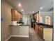 Well-lit kitchen features dark appliances, tile flooring, and plentiful cabinet space at 2585 Woodside Ridge Dr, Apopka, FL 32712