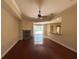Cozy living room with a stone fireplace, hardwood floors, and access to patio at 2585 Woodside Ridge Dr, Apopka, FL 32712