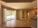 Bright living room features tile flooring, sliding glass doors to the backyard, and neutral paint at 2585 Woodside Ridge Dr, Apopka, FL 32712