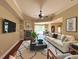 Comfortable living room featuring a fireplace, ceiling fan, and hardwood floors at 2585 Woodside Ridge Dr, Apopka, FL 32712
