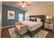 Staged main bedroom features carpet, ceiling fan, king bed, and decorative touches at 2585 Woodside Ridge Dr, Apopka, FL 32712