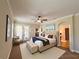 The Primary bedroom includes a ceiling fan, ensuite bathroom, and private balcony access at 2585 Woodside Ridge Dr, Apopka, FL 32712