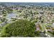 Picturesque aerial view of a residential neighborhood with mature trees and a lake at 2888 Middleton Cir, Kissimmee, FL 34743