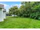 Expansive backyard featuring lush green grass, mature trees, and a storage shed in a peaceful setting at 2888 Middleton Cir, Kissimmee, FL 34743