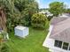Backyard view showcasing lush greenery and a storage shed at 2888 Middleton Cir, Kissimmee, FL 34743
