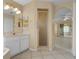 Bright bathroom featuring a glass shower, sink with cabinets, and large mirror with lights at 2888 Middleton Cir, Kissimmee, FL 34743