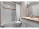Cozy bathroom featuring a shower-tub combo, white tile, and neutral tones, creating a clean and functional space at 2888 Middleton Cir, Kissimmee, FL 34743