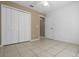 Comfortable bedroom showcasing tile floors, a ceiling fan, a closet with double doors, and fresh white paint at 2888 Middleton Cir, Kissimmee, FL 34743