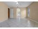 Sunny primary bedroom featuring tile floors, a ceiling fan, a large window, and an ensuite bathroom at 2888 Middleton Cir, Kissimmee, FL 34743