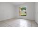 Bedroom featuring white walls, tile flooring and a window at 2888 Middleton Cir, Kissimmee, FL 34743