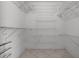 Spacious walk-in closet with wire shelving and tiled floor for organized storage at 2888 Middleton Cir, Kissimmee, FL 34743