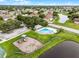 Aerial view of the community pool, playground, and lake with mature landscaping at 2888 Middleton Cir, Kissimmee, FL 34743