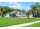 Well-kept single-story home boasts beautiful landscaping, an arched entryway, and a two-car garage at 2888 Middleton Cir, Kissimmee, FL 34743