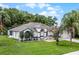 Well-maintained single-story home with lush green lawn and mature trees offering great curb appeal at 2888 Middleton Cir, Kissimmee, FL 34743