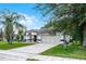 Single-story home featuring a two-car garage, arched entryway, and mature landscaping for added charm at 2888 Middleton Cir, Kissimmee, FL 34743