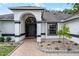 Close up view of the front door of a well-maintained home with clean landscaping and tiled walkway at 2888 Middleton Cir, Kissimmee, FL 34743