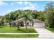 Inviting single-story home with a manicured lawn, mature palm tree, and a convenient two-car garage at 2888 Middleton Cir, Kissimmee, FL 34743