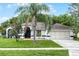 Charming single-story home featuring a well-manicured lawn, mature landscaping, and a two-car garage at 2888 Middleton Cir, Kissimmee, FL 34743
