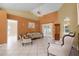 Spacious living room featuring tile floors, high ceilings, and sliding glass doors for natural light at 2888 Middleton Cir, Kissimmee, FL 34743
