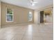 Bright and spacious living room featuring tile floors, two large windows, and sliding glass doors to an outdoor patio at 2888 Middleton Cir, Kissimmee, FL 34743