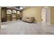 Spacious living room features tiled floors, built-in shelving, and comfortable seating with neutral tones at 2888 Middleton Cir, Kissimmee, FL 34743