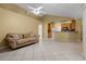 Open living area featuring a tile floor, a comfortable sofa, and an open view to the kitchen for easy entertaining at 2888 Middleton Cir, Kissimmee, FL 34743