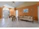 Bright living room featuring tile floors, comfortable seating, and a transom window above the front door at 2888 Middleton Cir, Kissimmee, FL 34743